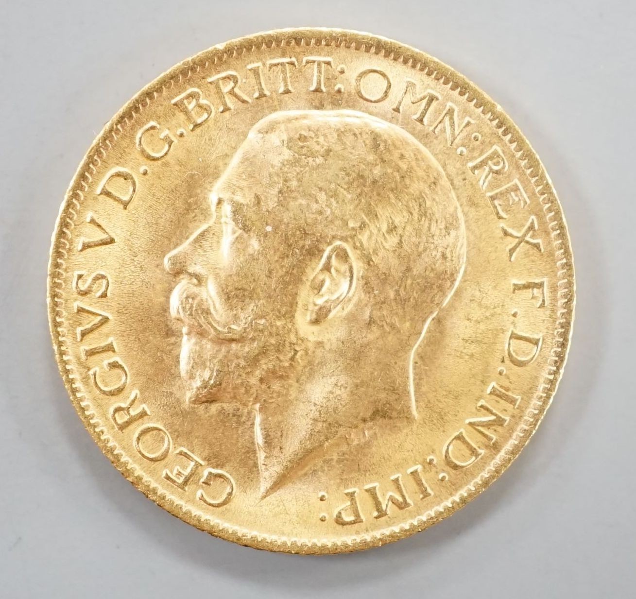 A George V 1915 gold sovereign.